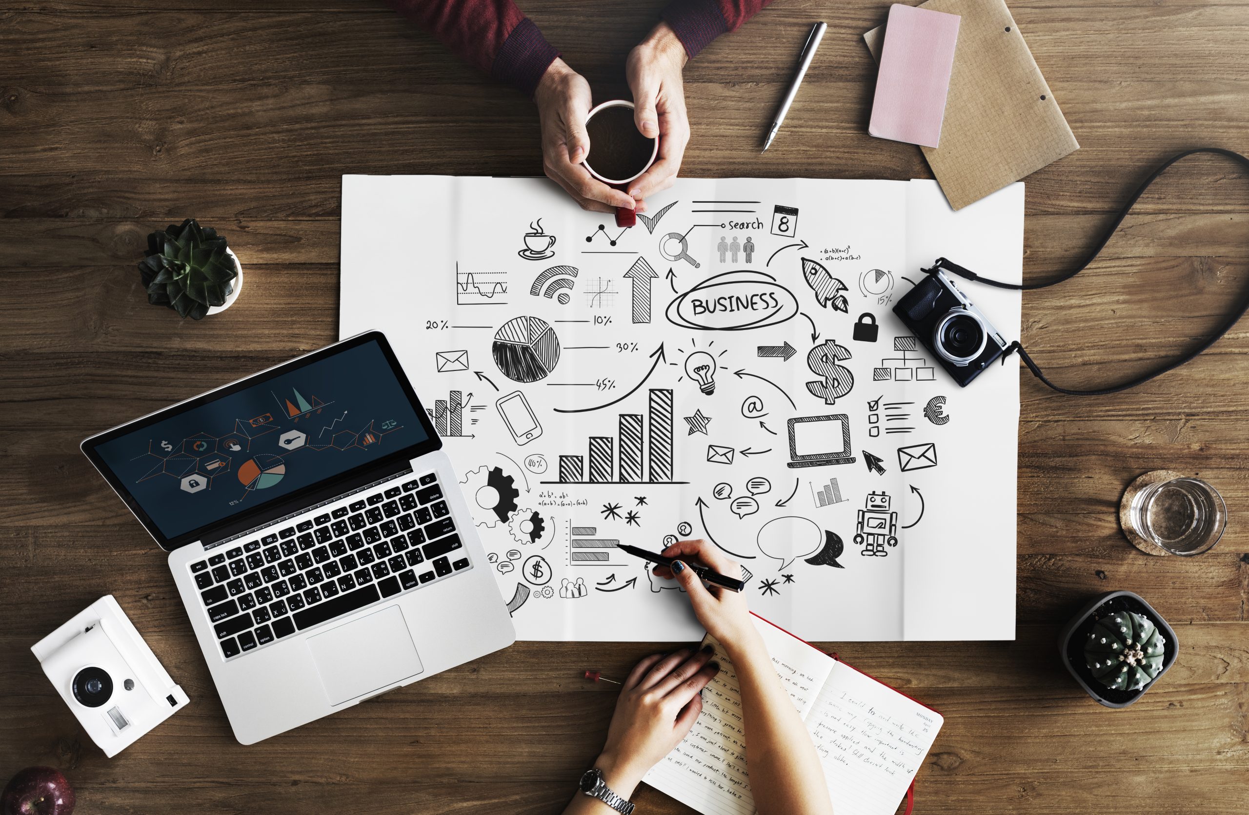 Digital Marketing Map and tools lying on wooden table
